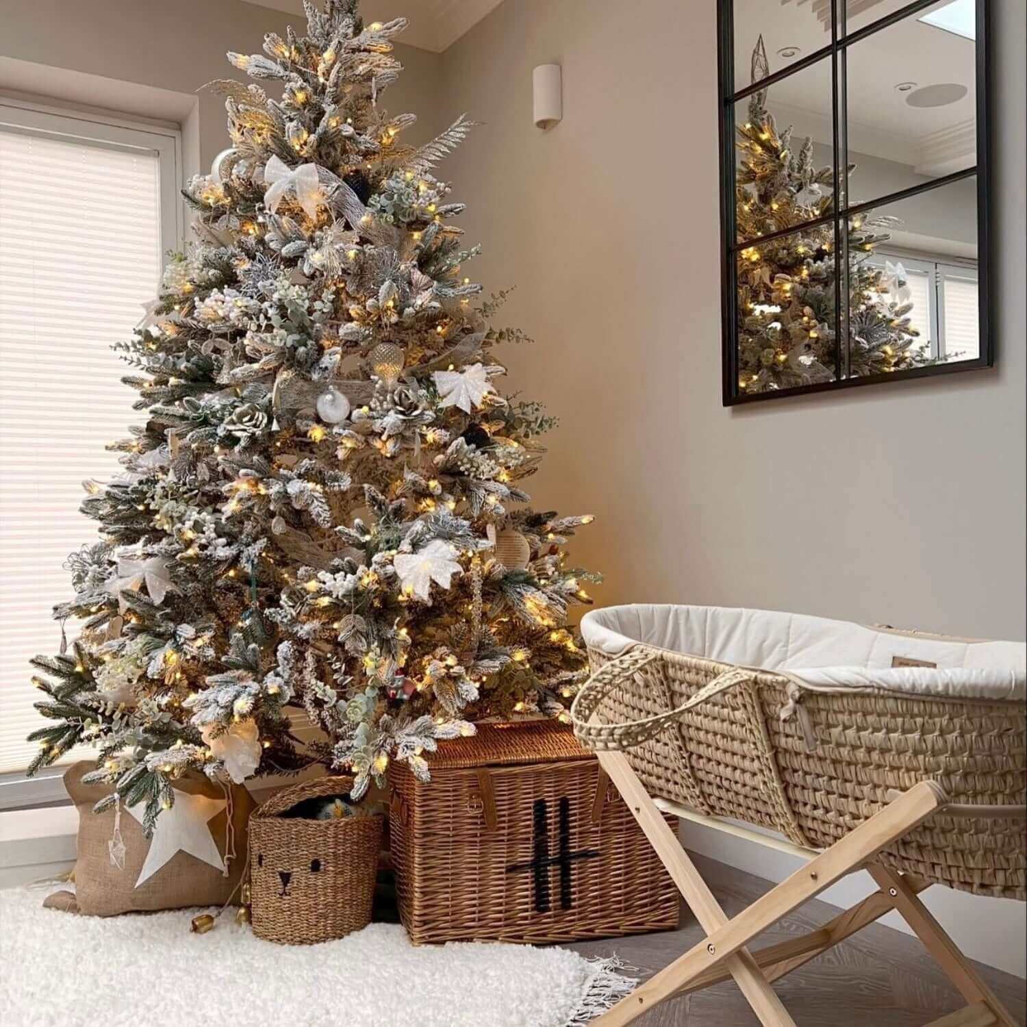 Cream Organic Palm Moses Basket on Natural folding stand in the living room next to a beautifully decorated Christmas tree | Preparing for Baby's First Christmas | Tips and advice - Clair de Lune UK