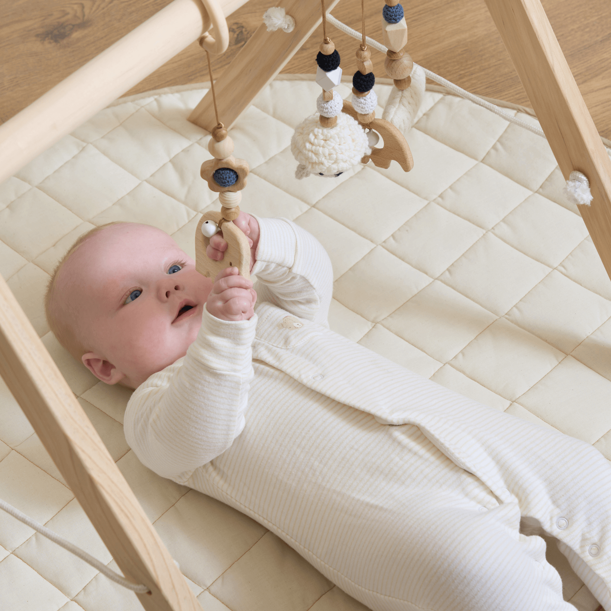 Baby lying on the Organic play mat | Top 5 Reasons the Clair de Lune Wooden Play Gym is the Perfect Christmas Gift - Clair de Lune UK