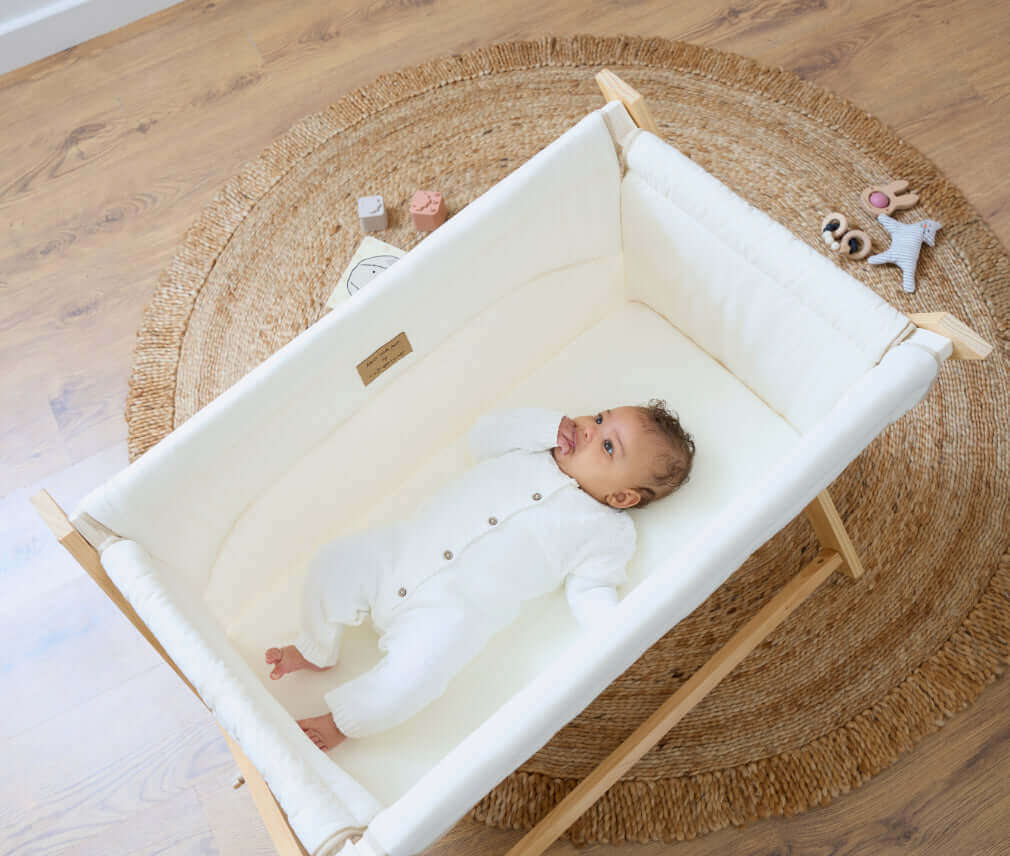 Newborn baby in the gold award winning organic folding crib, voted the best travel cot | Baby Safe Sleep While Travelling - Clair de Lune UK