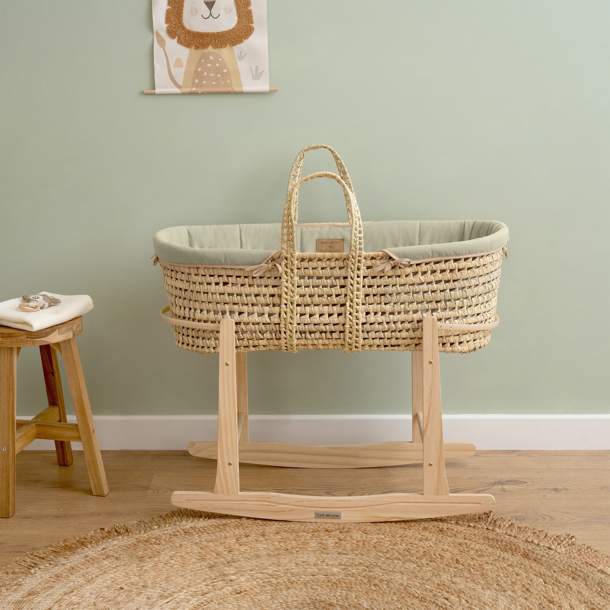 Sage Organic Palm Moses Basket with natural pine rocking stand in a neutral sage green nursery | Co-sleepers - Clair de Lune UK