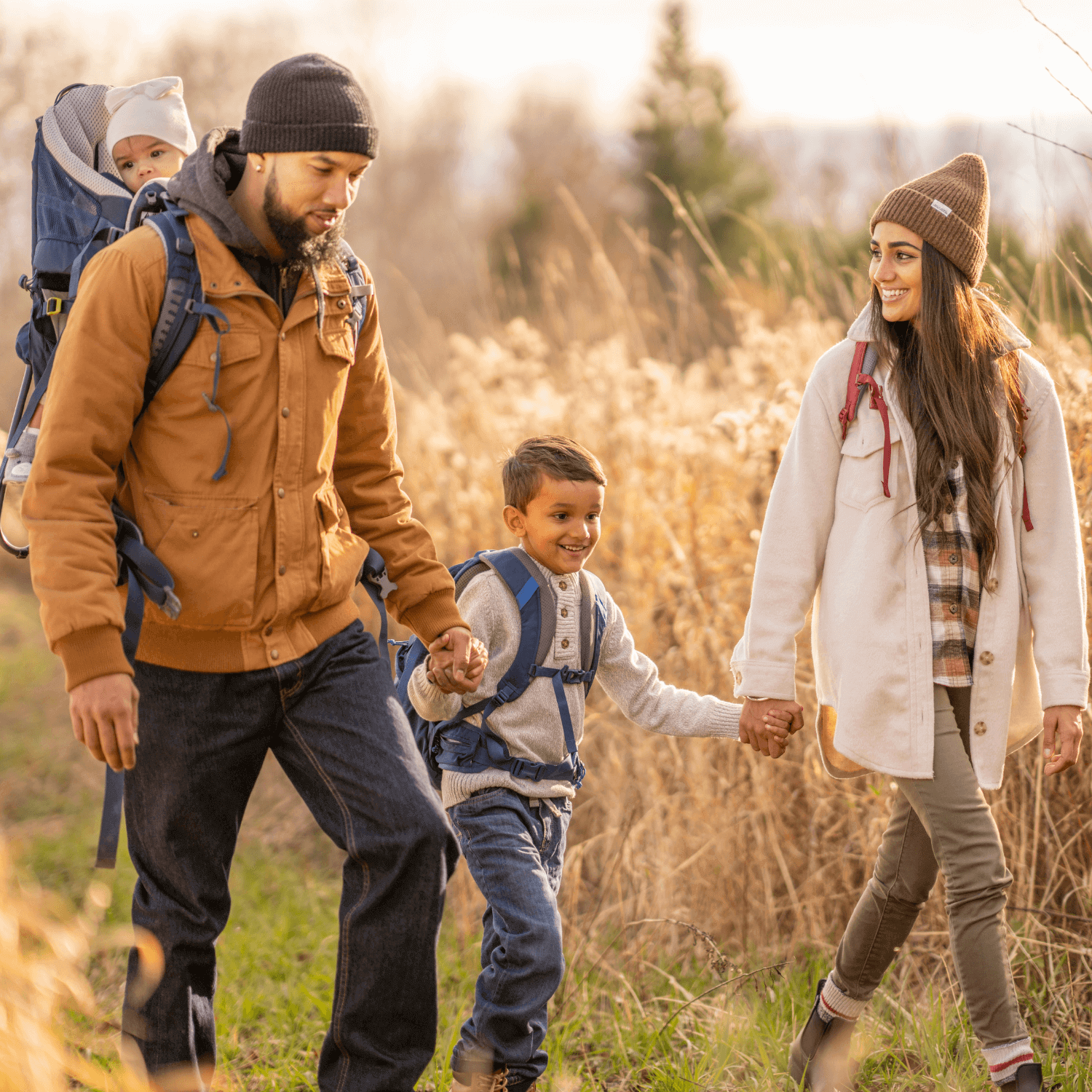 New Year, New Adventures - Family-Friendly Resolutions | Mum, dad and toddler wrapped up in winter coats and hiking gear taking a stroll through the forest | Family New Year - Clair de Lune UK