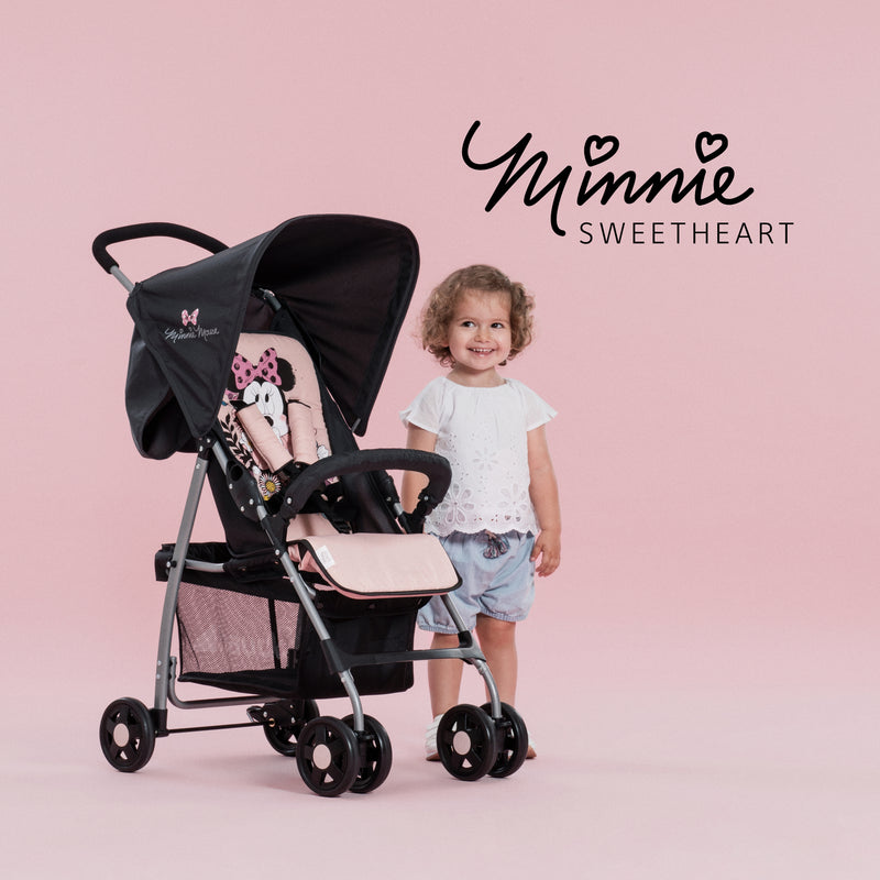 Toddler standing next to her pink Minnie Sweetheart Hauck Disney Sport Pushchair | Strollers, Pushchairs & Prams | Pushchairs, Carrycots & Car Seats Baby | Travel Essentials - Clair de Lune UK