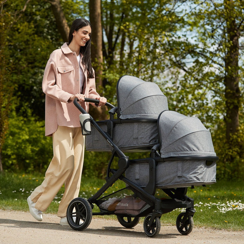Mum walking in the park with her twins sleeping in the Hauck Atlantic Twin Tandem Pushchair | Strollers, Pushchairs & Prams | Pushchairs, Carrycots & Car Seats Baby | Travel Essentials - Clair de Lune UK