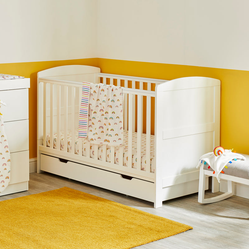 White Ickle Bubba Coleby Classic Cot Bed with a matching drawer in a fun yellow nursery room | Cots, Cot Beds & Toddler Beds | Nursery Furniture - Clair de Lune UK