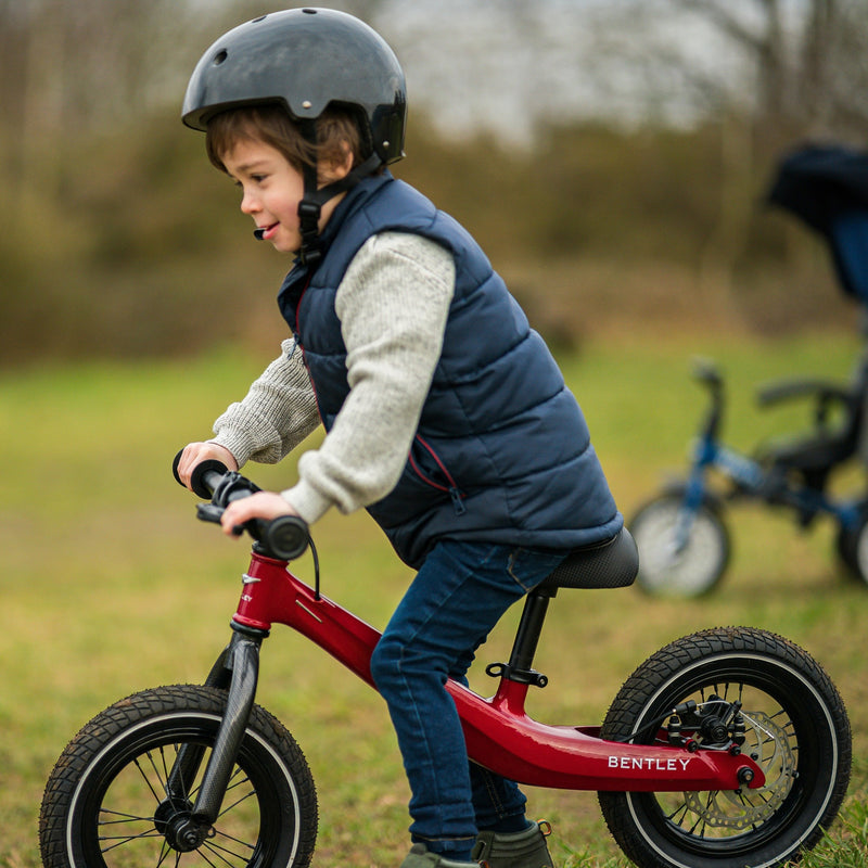 Little boy riding his Dragon Red Bentley Balance Bike in the English countryside | Toddler Bikes | Montessori Activities For Babies & Kids - Clair de Lune UK
