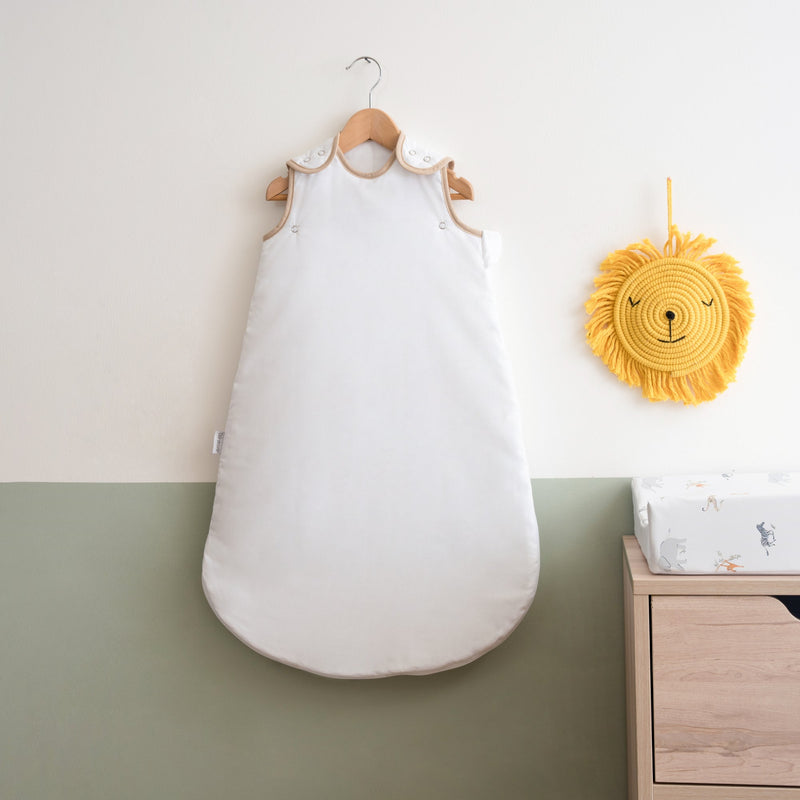 White Organic Sleeping Bag (0-6 Months) on a wall-mount hanger in a Scandi Sage Green nursery | Baby Sleep Bags, Shawls, Swaddles & Sleepbags | Nightwear | Nursery - Clair de Lune UK