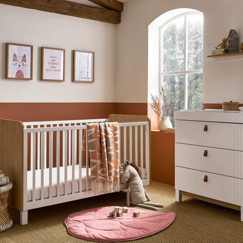 The 2-Piece Room Set including a white and natural cot bed and a matching dresser from the White and Natural CuddleCo Rafi Nursery Room Sets in a Biritsh countryside cottage nursery room | Nursery Furniture Sets | Room Sets | Nursery Furniture - Clair de 