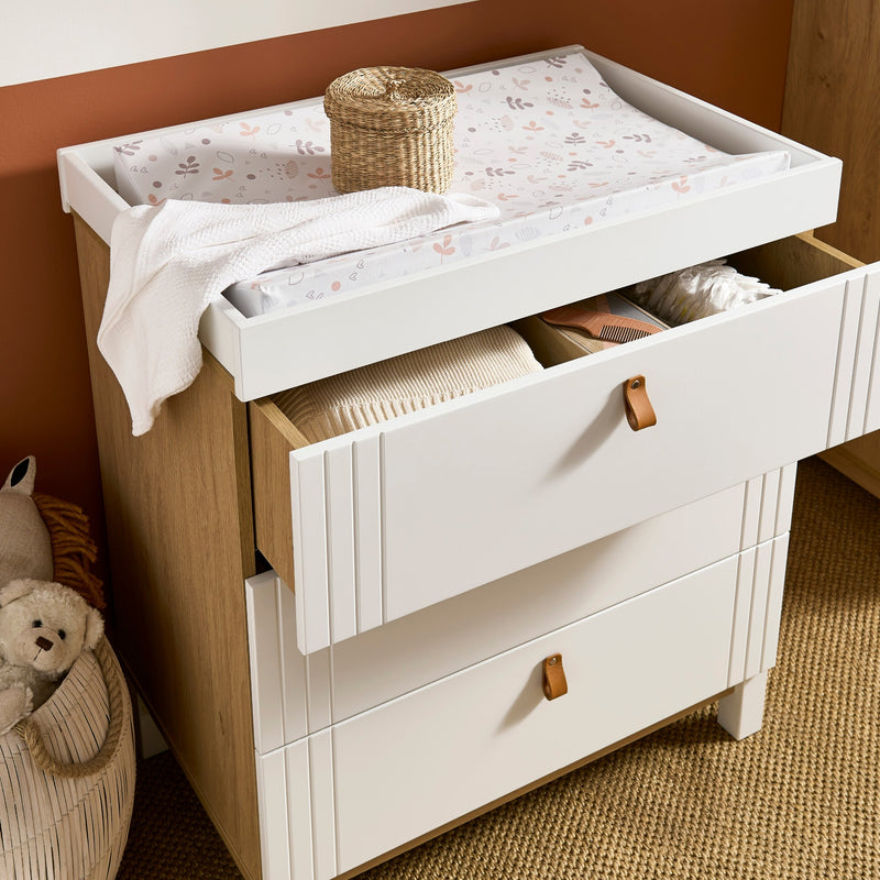 The spacious drawers of the white and natural changer from the White and Natural CuddleCo Rafi Nursery Room Sets in a Biritsh countryside cottage nursery room | Nursery Furniture Sets | Room Sets | Nursery Furniture - Clair de Lune UK