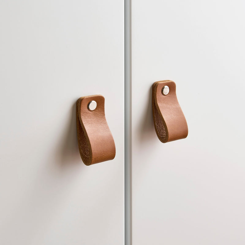 The leather handles of the white and natural double wardrobe from the White and Natural CuddleCo Rafi Nursery Room Sets in a Biritsh countryside cottage nursery room | Nursery Furniture Sets | Room Sets | Nursery Furniture - Clair de Lune UK