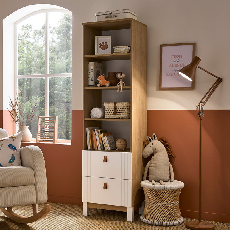The white and natural bookcase of the White and Natural CuddleCo Rafi Nursery Room Sets in a Biritsh countryside cottage nursery room | Nursery Furniture Sets | Room Sets | Nursery Furniture - Clair de Lune UK
