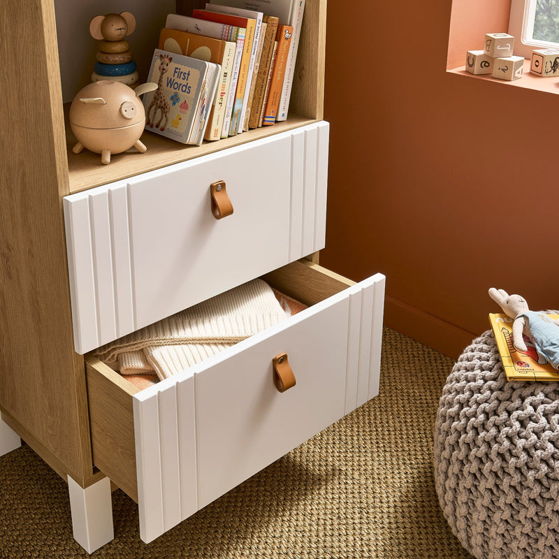 The spacious drawers of the white and natural bookcase from the White and Natural CuddleCo Rafi Nursery Room Sets in a Biritsh countryside cottage nursery room | Nursery Furniture Sets | Room Sets | Nursery Furniture - Clair de Lune UK