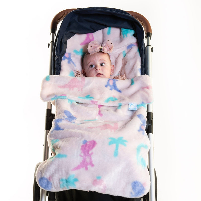 Baby playing in the Jurassic Jubilee Buggysnuggle Snuggle Fur Footmuff | Pushchair Cosytoes & Footmuffs | Travel Accessories - Clair de Lune UK