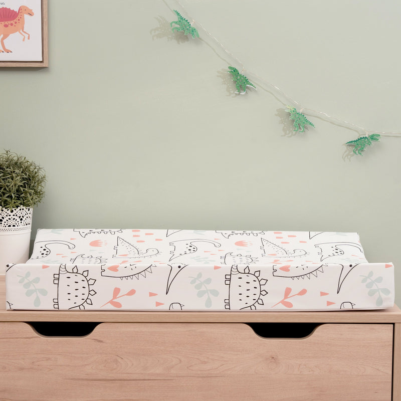 Dinosaur Anti-Roll Wedge Baby Changing Mat on a natural baby dresser | Baby Changing Mats | Baby Bath Time Essentials - Clair de Lune UK