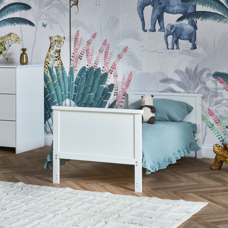 White Evie Cot Bed transformed to a toddler bed from the Obaby Evie Room Sets in a jungle safari inspired nursery room | Nursery Furniture Sets | Room Sets | Nursery Furniture - Clair de Lune UK
