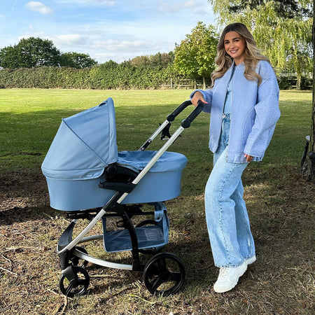 Dani Dyer pushing her blue pastel pushchair from the My Babiie MB200i Dani Dyer Blue Plaid iSize Travel System | Buggies, Strollers & Pushchairs | Travel With Baby - Clair de Lune UK