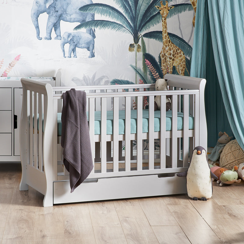 The cot bed of the warm grey Obaby Stamford Mini Sleigh Cot & Changing Unit with an adjustable platform in a jungle dream nursery room | Nursery Furniture Sets | Room Sets | Nursery Furniture - Clair de Lune UK