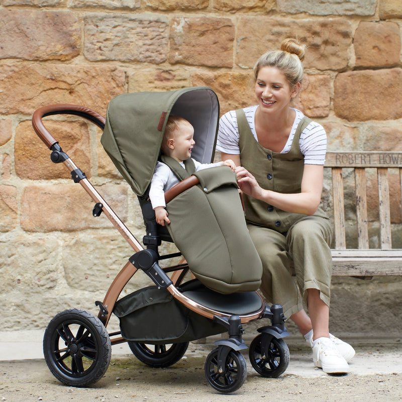 Mum sitting next to her baby in the a matching footmuff on the Woodland Green Ickle Bubba Stomp V4 2 in 1 Pushchair & Carrycot | Pushchairs and Travel Systems | Baby & Kid Travel - Clair de Lune UK