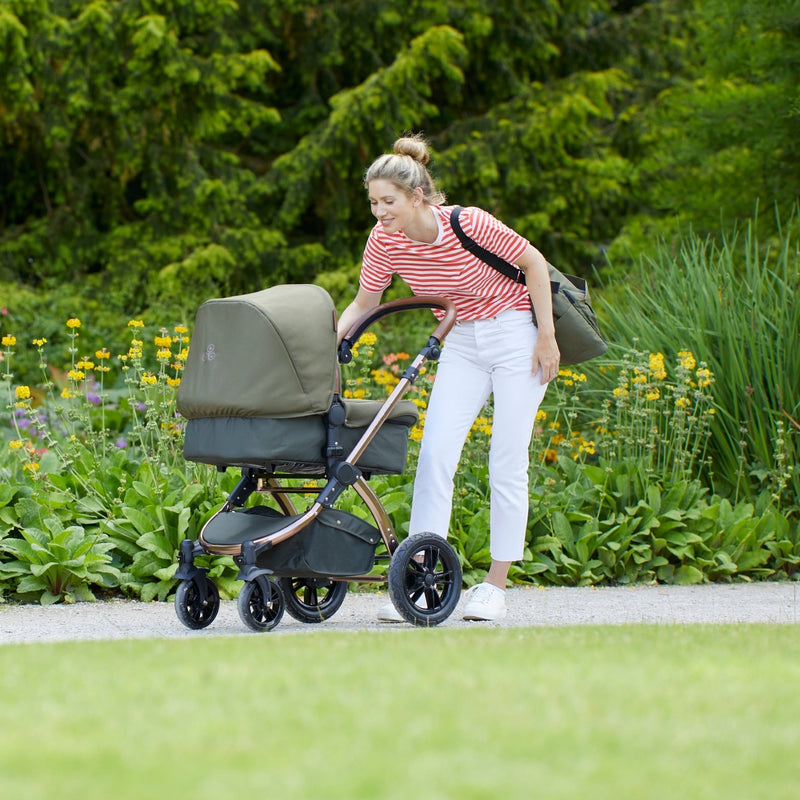 Mum checking her baby sleeping in the Woodland Green Ickle Bubba Stomp V4 2 in 1 Pushchair & Carrycot | Pushchairs and Travel Systems | Baby & Kid Travel - Clair de Lune UK