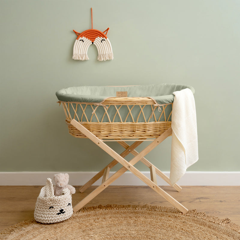 Sage Green Organic Natural Wicker Moses Basket on the Natural Folding Stand in a Sage Green Scandi nursery room | Moses Baskets | Co-sleepers | Nursery Furniture - Clair de Lune UK