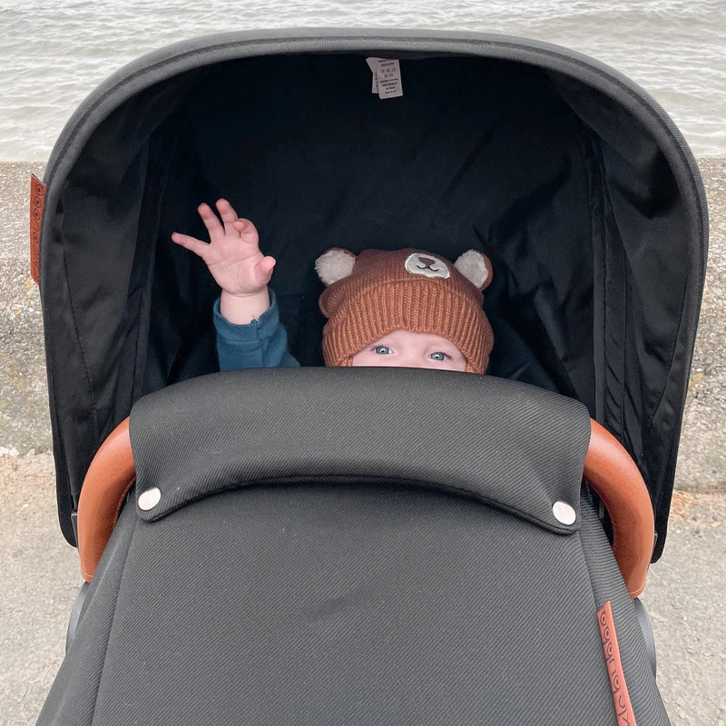 Baby playing in the carrycot of the Midnight Black Ickle Bubba Stomp V4 2 in 1 Pushchair & Carrycot | Pushchairs and Travel Systems | Baby & Kid Travel - Clair de Lune UK