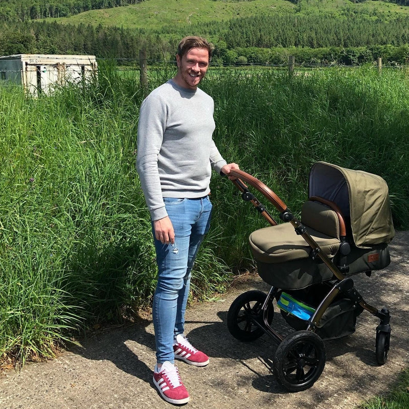 Dad pushing his Woodland Green Ickle Bubba Stomp V4 2 in 1 Pushchair & Carrycot | Pushchairs and Travel Systems | Baby & Kid Travel - Clair de Lune UK