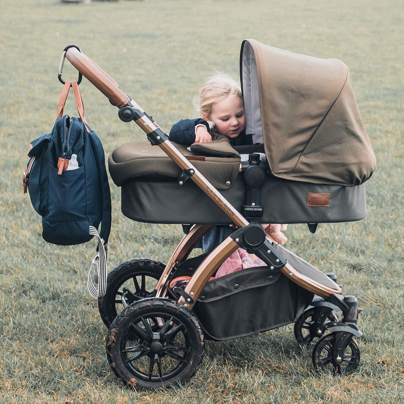 Baby sitting in the carrycot of the Woodland Green Ickle Bubba Stomp V4 2 in 1 Pushchair & Carrycot | Pushchairs and Travel Systems | Baby & Kid Travel - Clair de Lune UK
