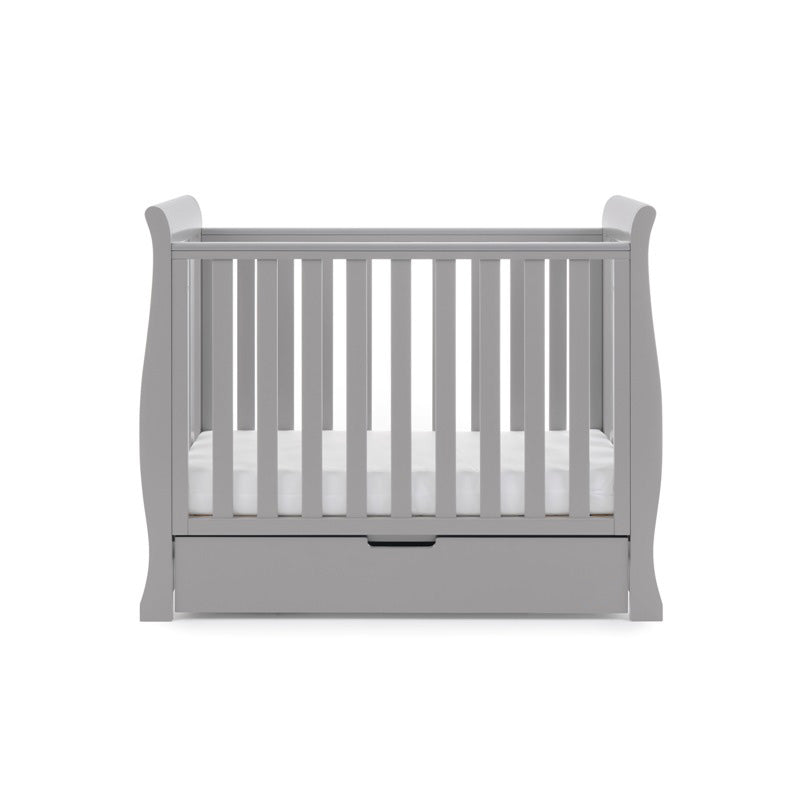 Warm grey Obaby Stamford Space Saver Cot coming complete with a white mattress and a matching under drawer | Cots, Cot Beds, Toddler & Kid Beds | Nursery Furniture - Clair de Lune UK