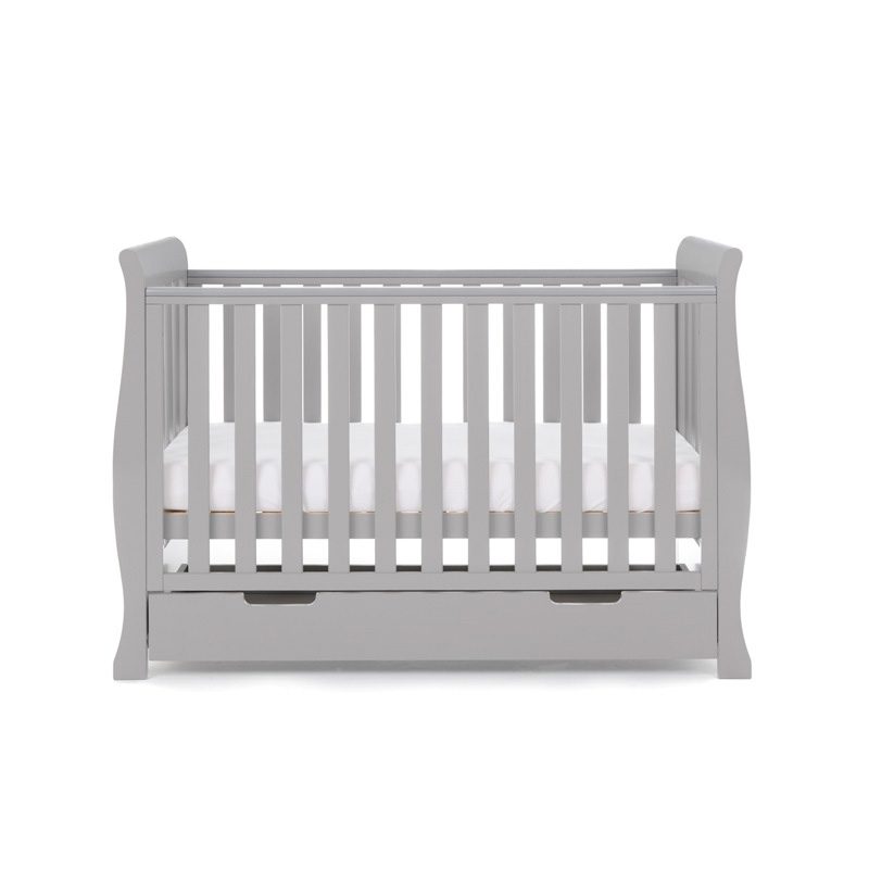 The warm grey Obaby Stamford Mini Sleigh Cot Bed with an adjustable platform at a medium level | Cots, Cot Beds, Toddler & Kid Beds | Nursery Furniture - Clair de Lune UK