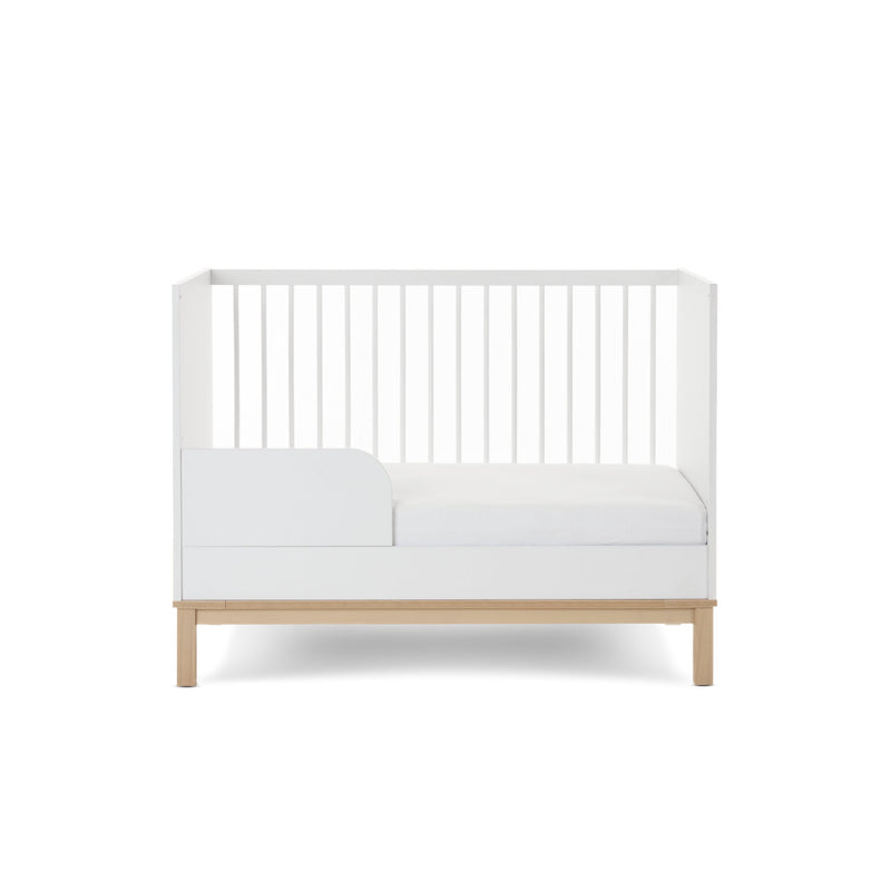 The white and natural Obaby Astrid Mini Cot Bed transformed to a toddler bed with a toddler rail | Cots, Cot Beds, Toddler & Kid Beds | Nursery Furniture - Clair de Lune UK