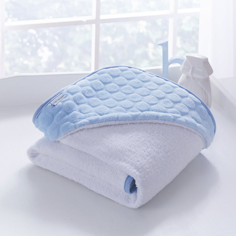 Folded Blue Marshmallow Hooded Towel for organising next to a white window | Baby Bathing & Changing Essentials - Clair de Lune UK