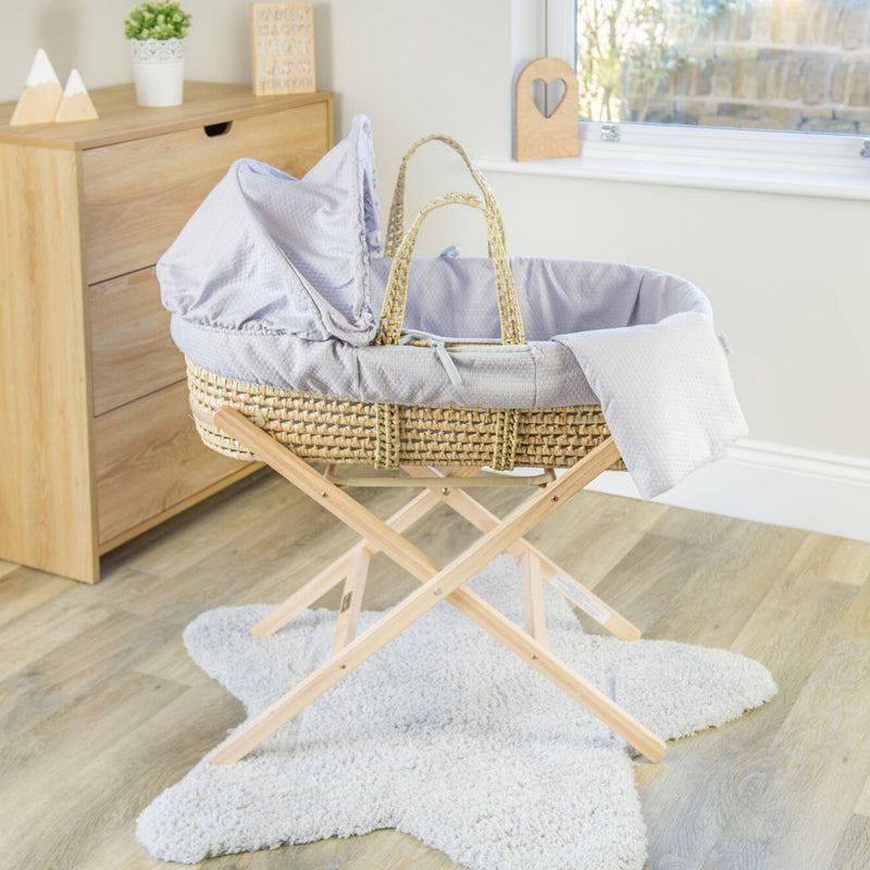 Grey Cotton Dream Palm Moses Basket on the Natural Compact Folding Stand in a minimalist bedroom | Moses Baskets and Stands | Co-sleepers | Nursery Furniture - Clair de Lune UK