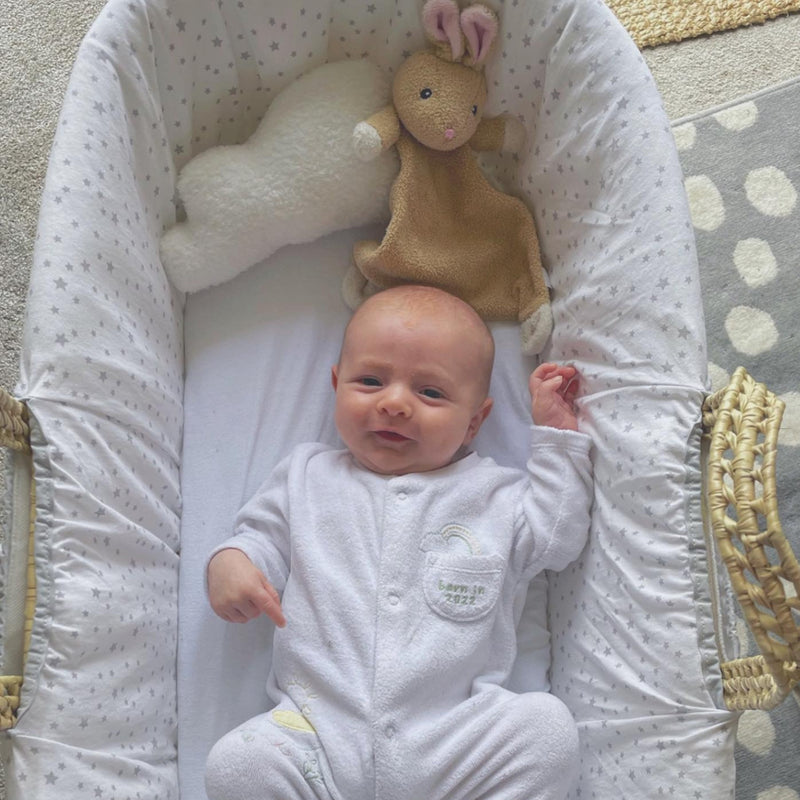 Little customer is playing and smiling in our Special Buy - Essentials Moses Basket With Stand & Blanket | Moses Baskets and Stands | Co-sleepers | Nursery Furniture - Clair de Lune UK