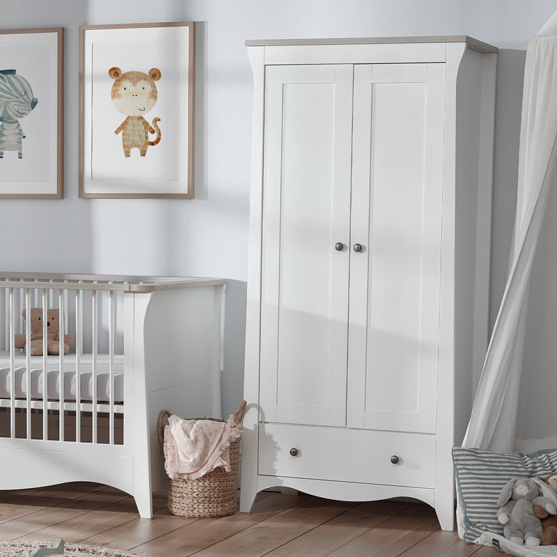 The cot bed and wardrobe of the Ash CuddleCo Clara 3pc Nursery Set - 3 Drawer Dresser/Changer, Cot Bed & Wardrobe in a natural white gender-neutral nursery | Nursery Furniture Sets | Room Sets | Nursery Furniture - Clair de Lune UK