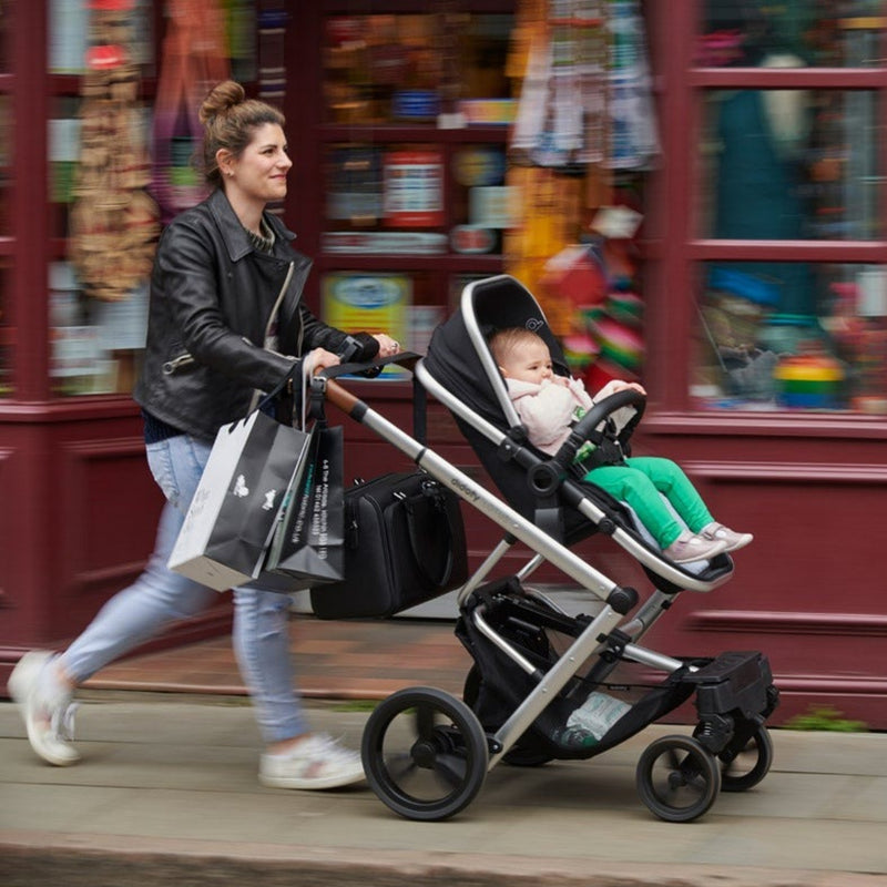 Mom pushing the Didofy Black Lotus Auto Folding Travel System with the baby on it | Travel Systems | Pushchairs and Travel Systems | Baby & Kid Travel - Clair de Lune UK