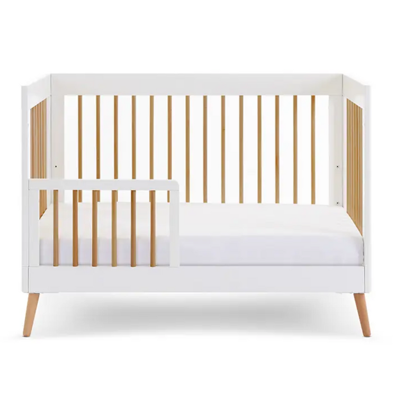  The white cot bed of the Obaby Maya Mini 2 Piece Room Set in white transformed to a white and natural toddler bed with a toddler rail for safety | Nursery Furniture Sets | Room Sets | Nursery Furniture - Clair de Lune UK