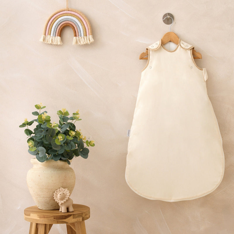Natural Cream Organic Sleeping Bag (0-6 Months) on a wall-mount hanger in a Scandi nursery | Baby Sleep Bags, Shawls, Swaddles & Sleepbags | Nightwear | Nursery - Clair de Lune UK