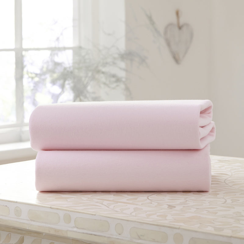2 Pack Pink Cotton Fitted Pram/Crib Sheets - 90 x 40 cm on a counter top | Soft Baby Sheets | Cot, Cot Bed, Pram, Crib & Moses Basket Bedding - Clair de Lune UK
