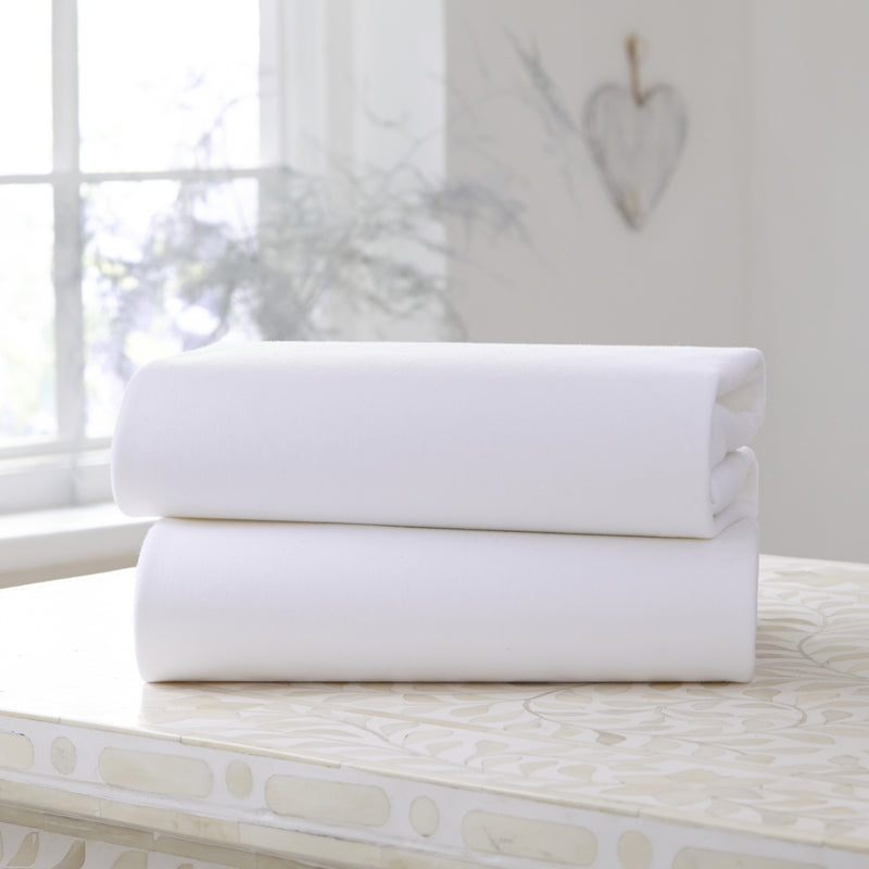 2 Pack White Cotton Fitted Pram/Crib Sheets - 90 x 40 cm on a counter top | Soft Baby Sheets | Cot, Cot Bed, Pram, Crib & Moses Basket Bedding - Clair de Lune UK