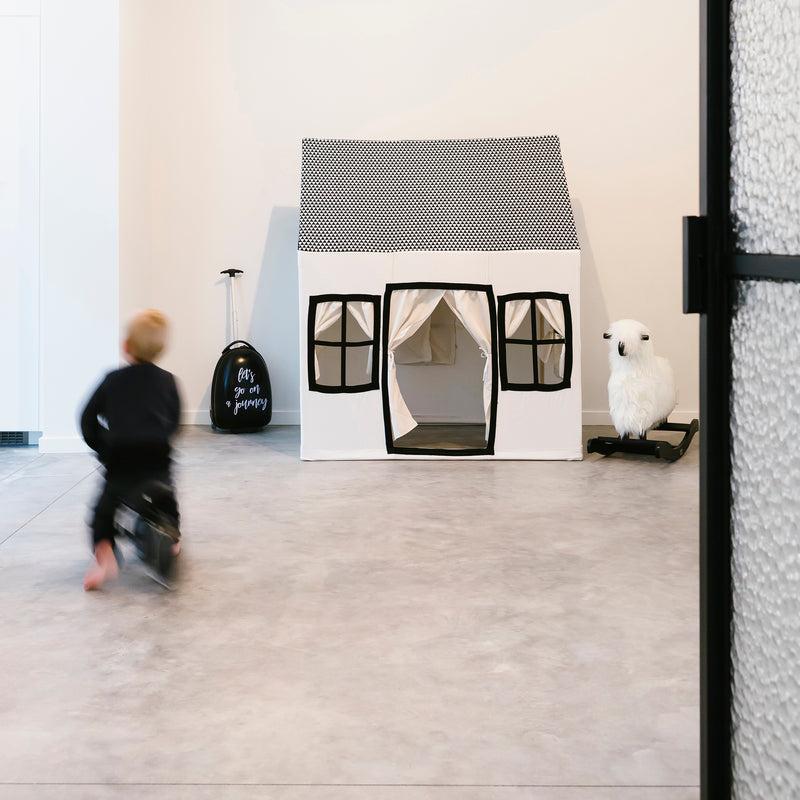 Kid playing next to the Childhome Big Cotton Playhouse in a playroom | Nursery Storage | Nursery Furniture - Clair de Lune UK