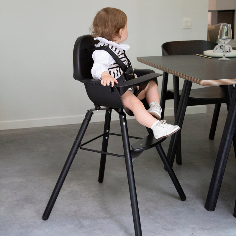 Toddler having dinner on the Black Childhome Evolu 2 Chair - 2 In 1 with Bumper | Highchairs | Feeding & Weaning - Clair de Lune UK