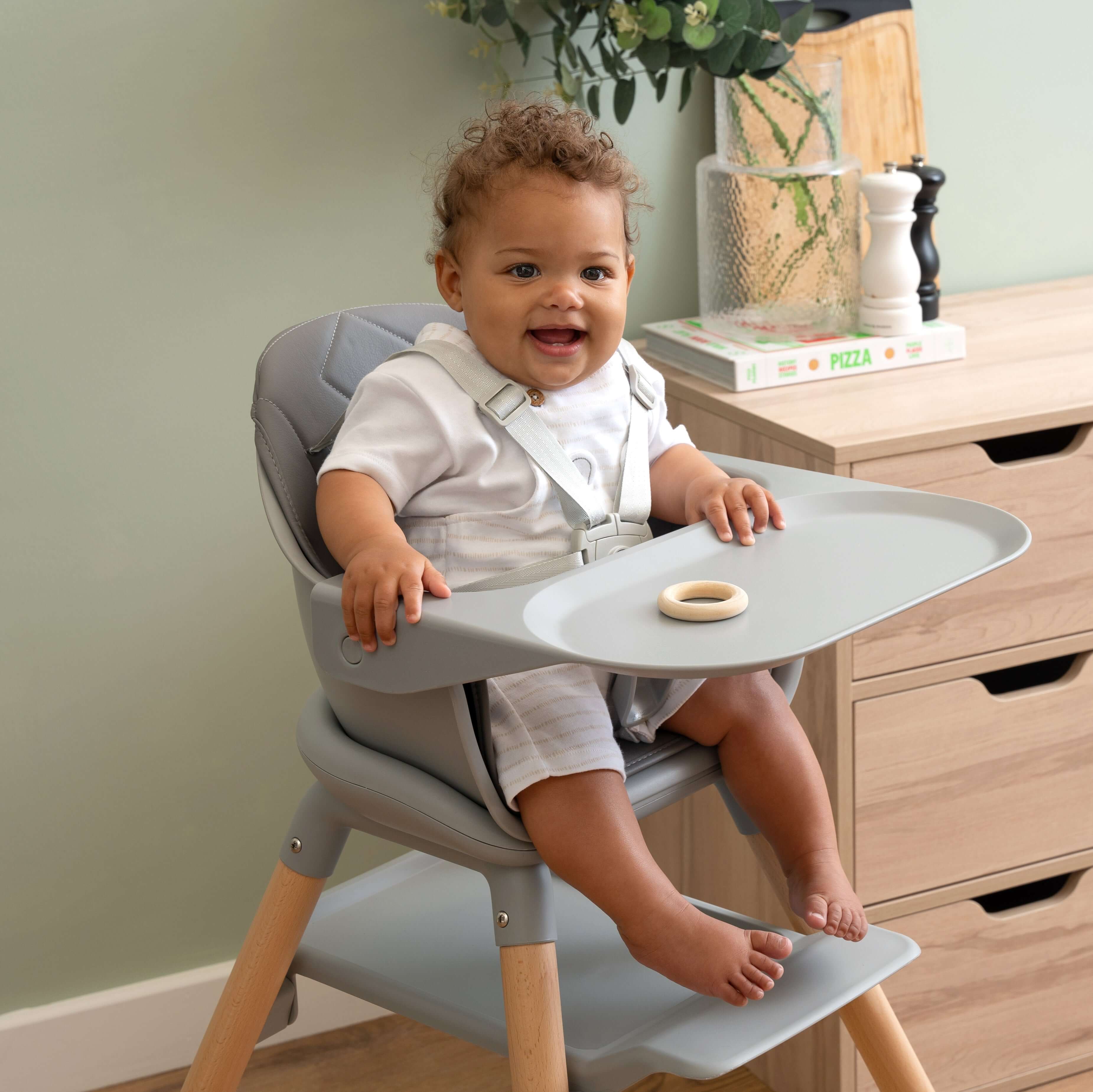 Happy baby sat in the Grey 6in1 High Chair in the kitchen | High Chairs | Feeding & Weaning - Clair de Lune UK