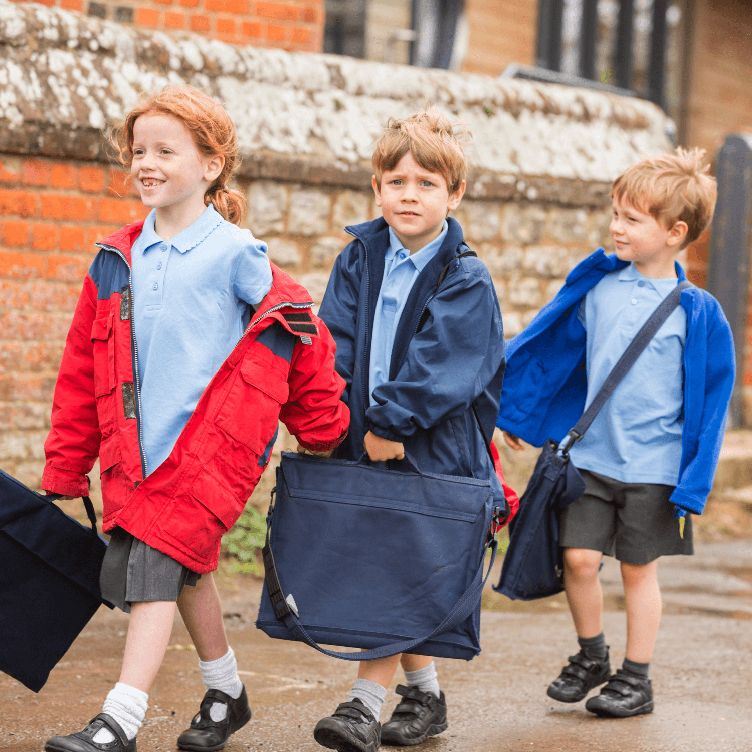 Children wearing school uniforms and winter coats holding book bags on the school run | Back to School - Clair de Lune UK