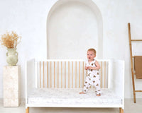 Toddler jumping on the mattress of the Essentials Cot Bed | Switch Your Baby from a Moses Basket to a Cot Bed - Clair de Lune UK