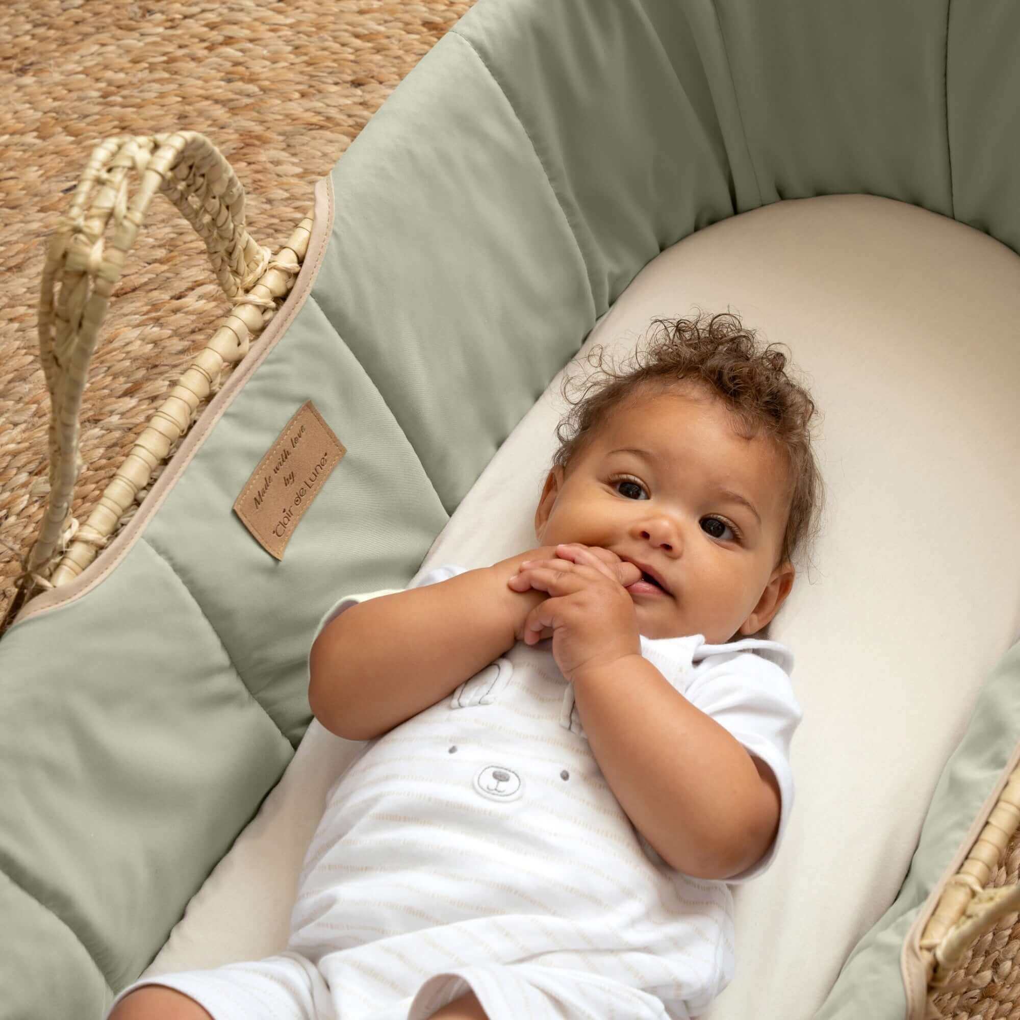 Baby lying in the Sage Organic Palm Moses Basket | Moses Basket Size Guide - Clair de Lune