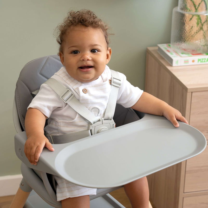 Happy baby dressed in white shirt sat in the 6in1 Eat & Play High Chair | Feeding & Weaning - Clair de Lune UK