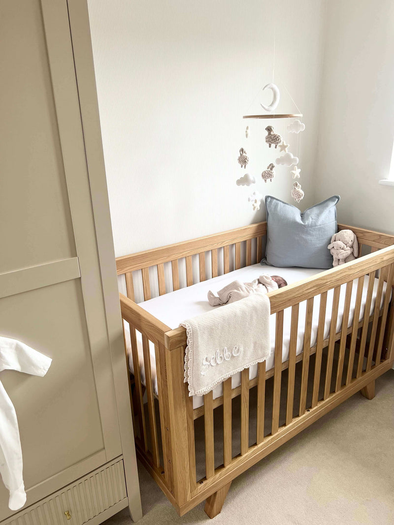 Newborn Sleeping in the Clair de Lune Solid Oak Cot Bed | What’s the Best Cot Bed for My Baby | Parenting & Buying Guides - Clair de Lune UK
