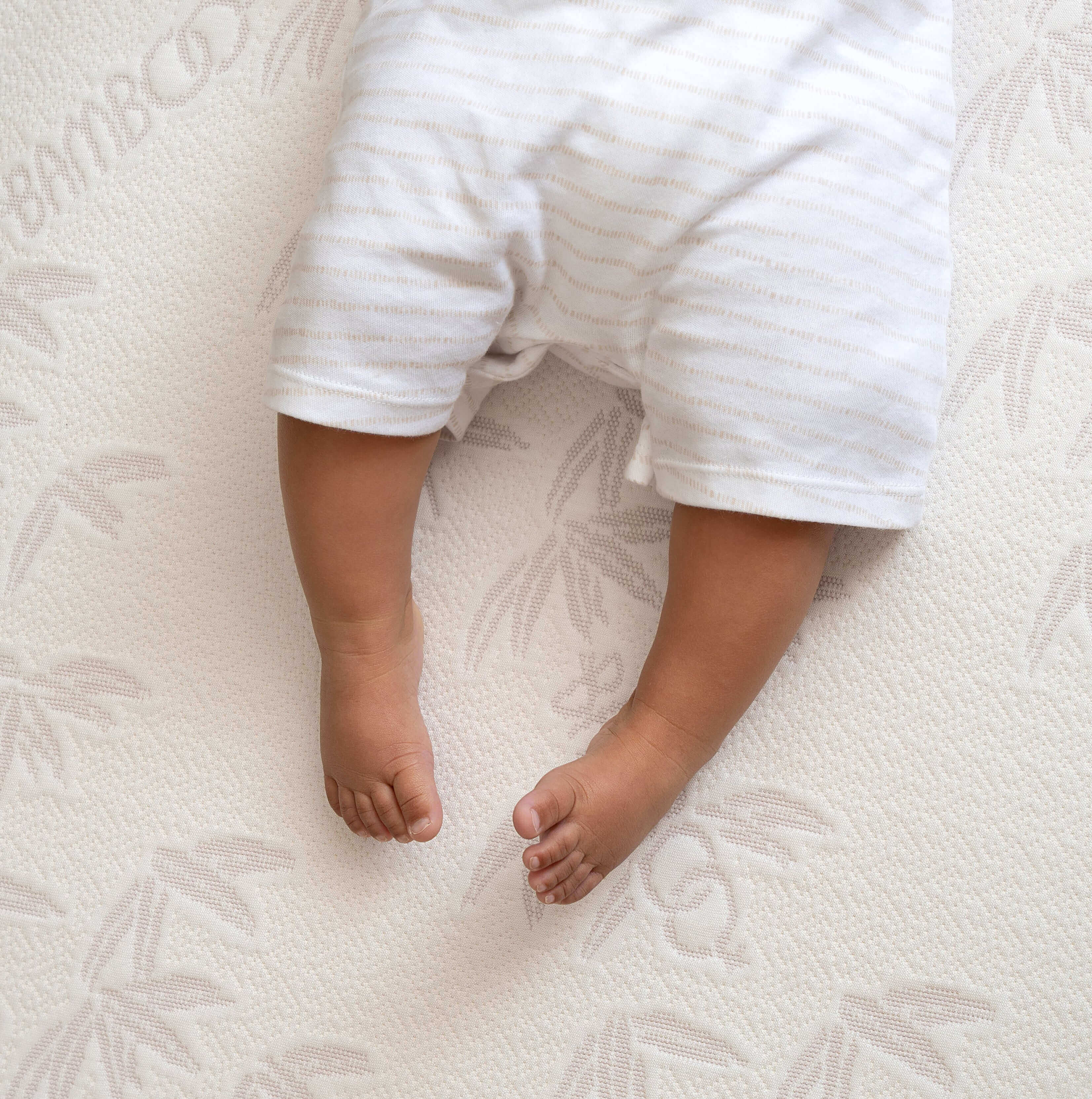 A baby's bare feet shown on top of the Natural Bamboo Cot Bed Mattress | A Guide to Finding the Perfect Cot Bed Mattress - Clair de Lune UK