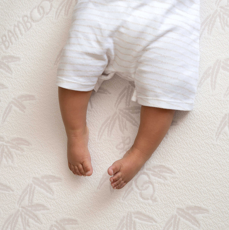 A baby's bare feet shown on top of the Natural Bamboo Cot Bed Mattress | A Guide to Finding the Perfect Cot Bed Mattress - Clair de Lune UK