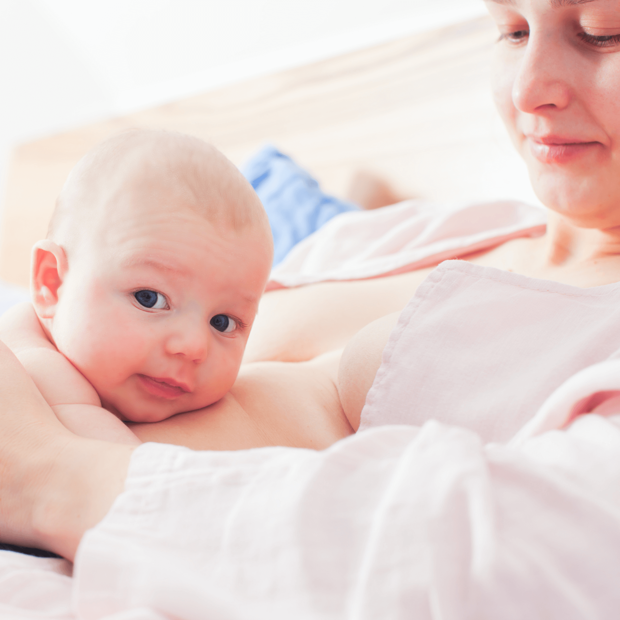 Smiling baby looking at the camera lying on mum's tummy | Family Time | Bonding with Baby - Clair de Lune UK