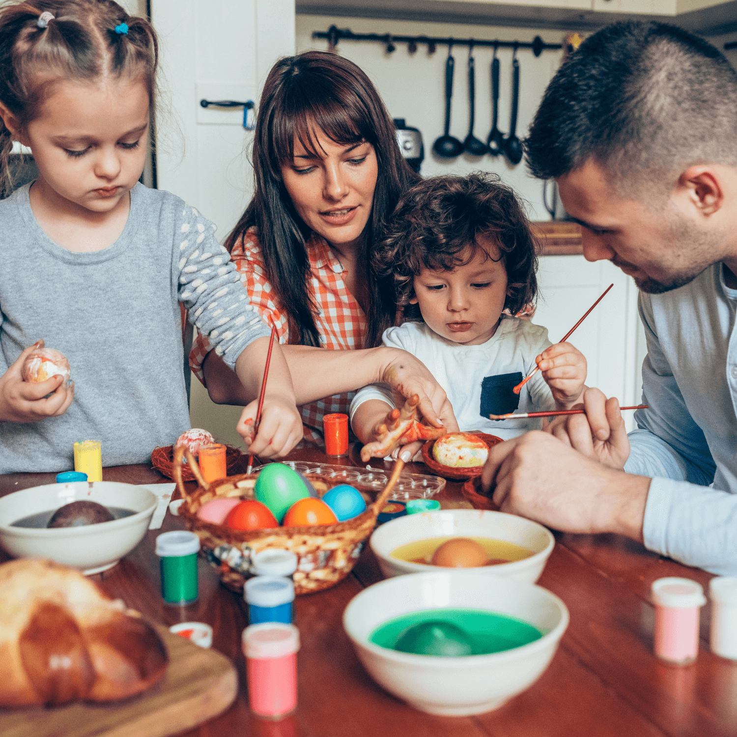 Family with toddlers painting easter eggs at home - Clair de Lune UK